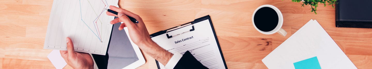 real estate agent giving contract to young couple